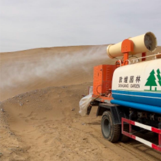 Sand shield truck spraying product on a dune in the desert